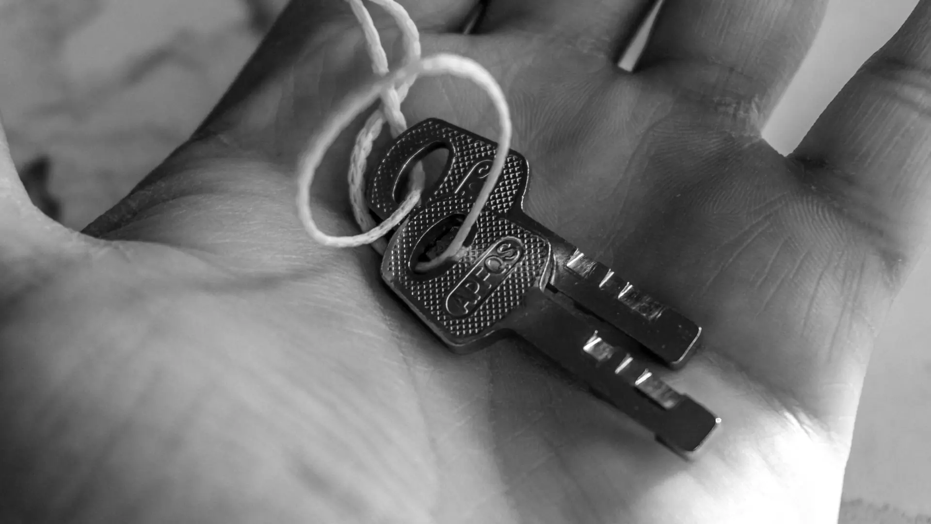 A set of house keys in an open hand