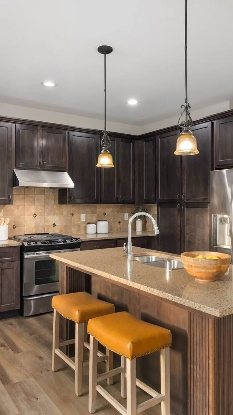 The kitchen of 14008 SE 21st Place, Bellevue: a long island with bar stools and dark cabinetry
