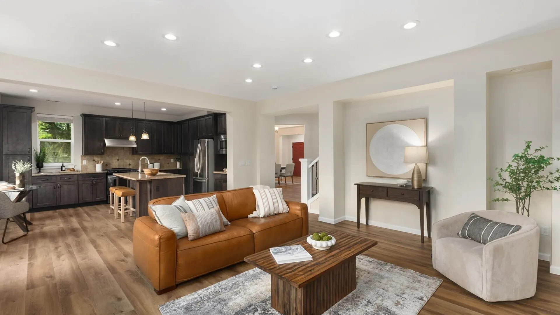 The living room of 14008 SE 21st Place, Bellevue: a fireplace, leather sofas and a wall of windows