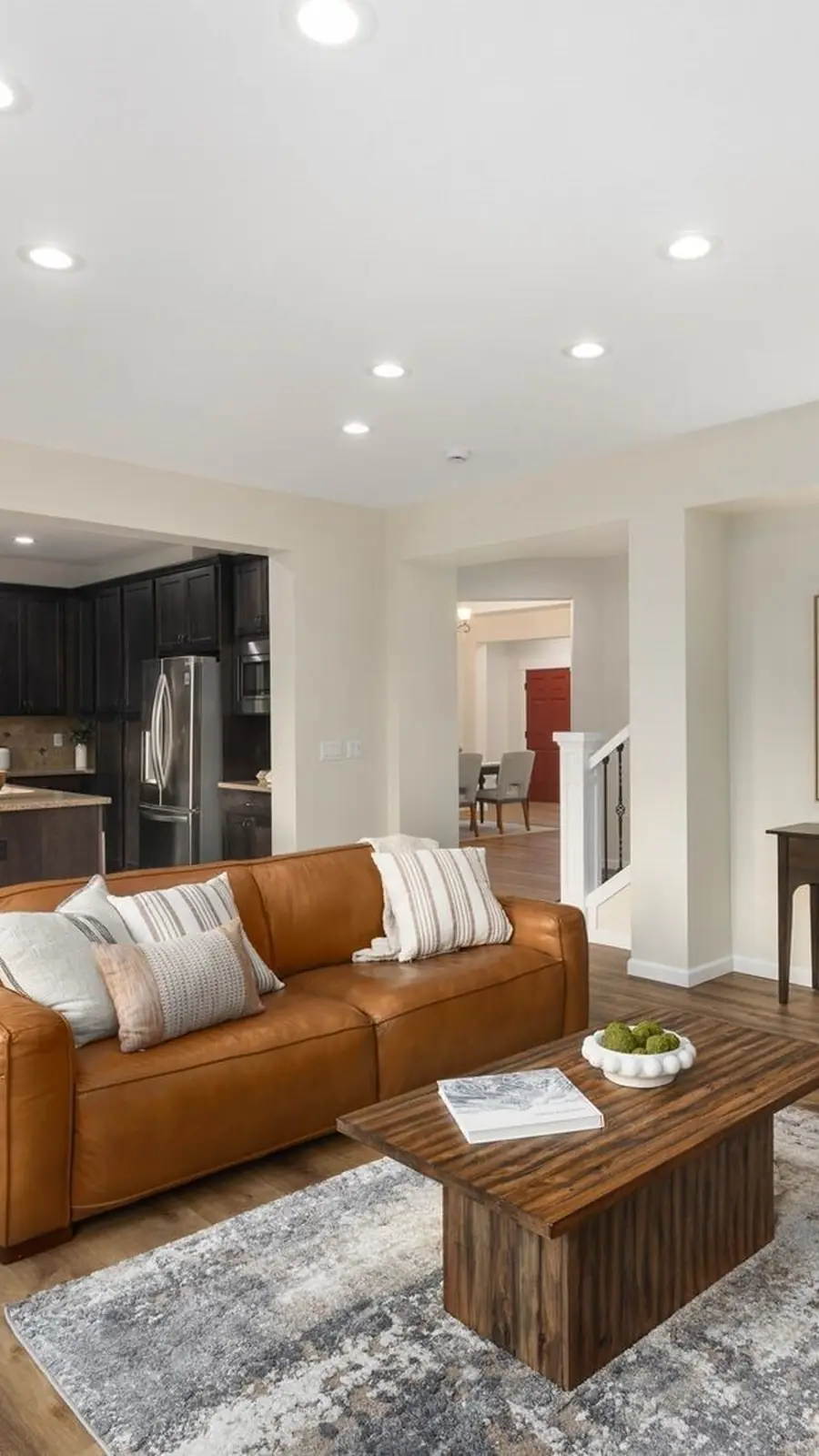 The living room of 14008 SE 21st Place, Bellevue: a fireplace, leather sofas and a wall of windows