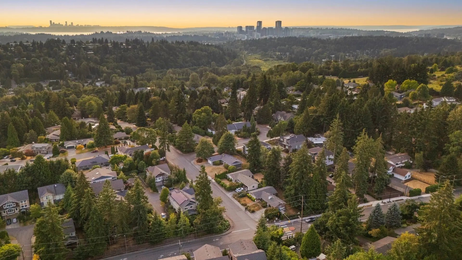 An aerial view over East Bellevue toward the downtown Bellevue skyline at dusk