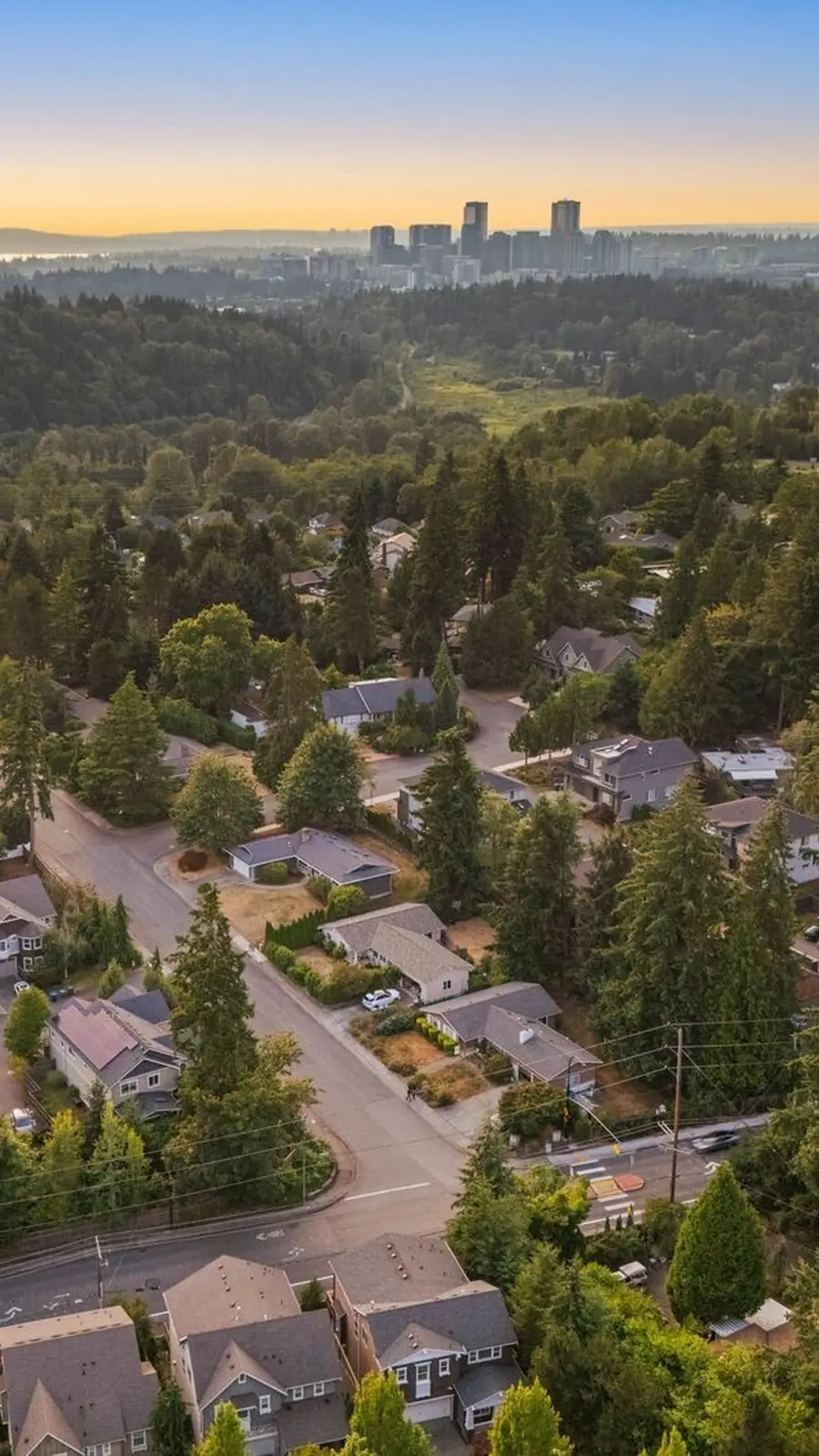 An aerial view over East Bellevue toward the downtown Bellevue skyline at dusk